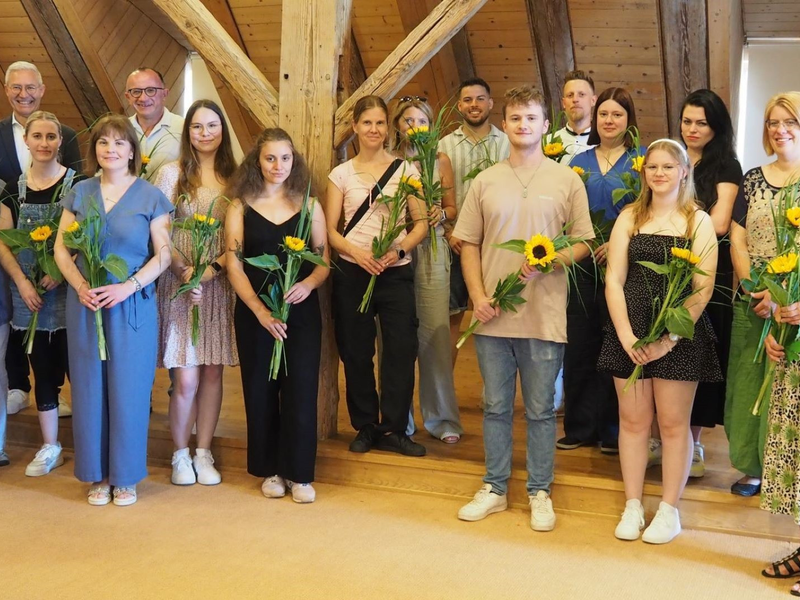 Eine Gruppe von Menschen mit Sonnenblumen in der Hand